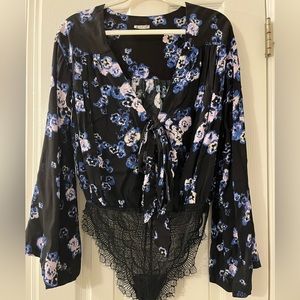 Free People body suit. Never worn. Size XS but fits like a small